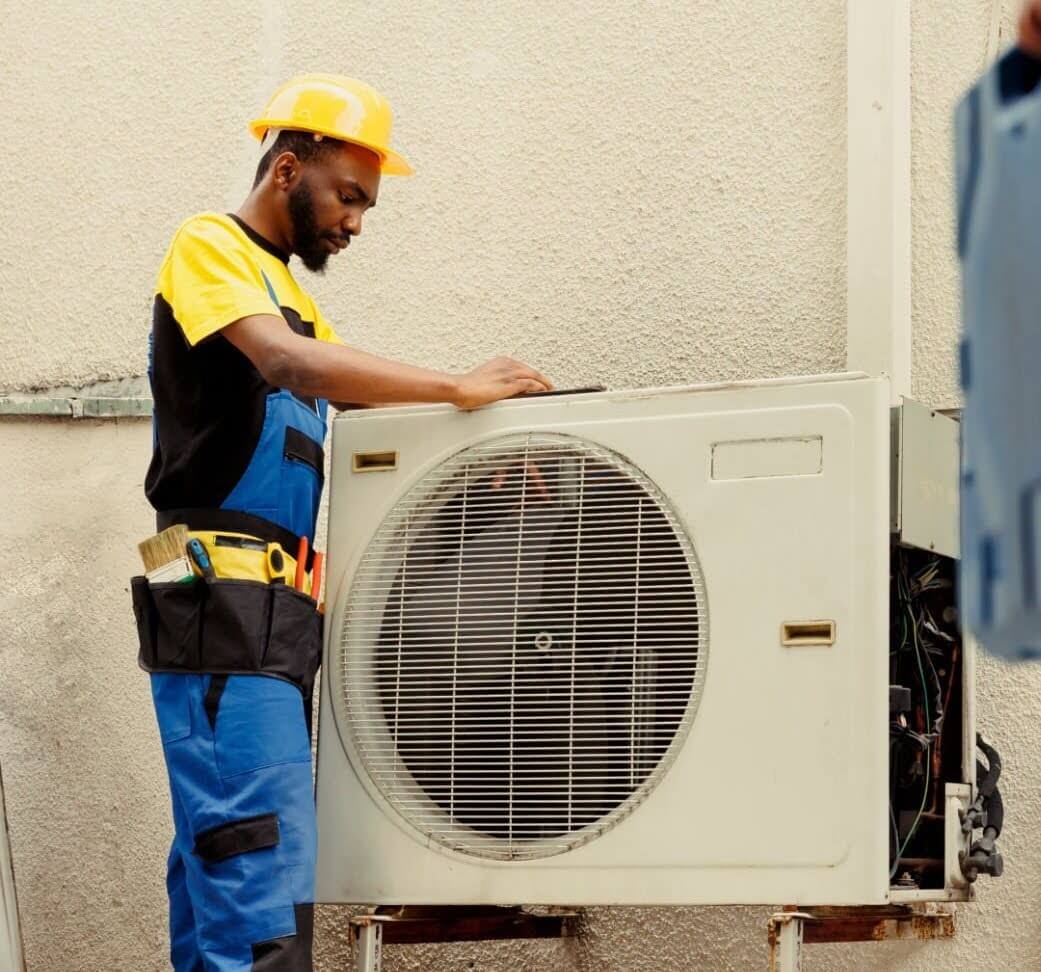 Skilled Bowie HVAC technician investigating ductless mini-split issue.